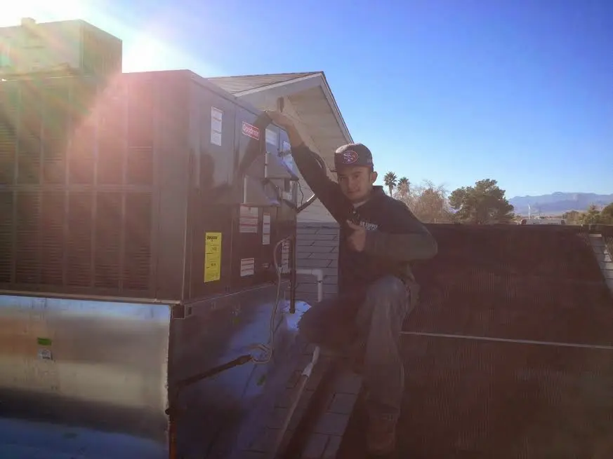 HVAC technician performing HVAC Inspection on a rooftop unit in Fallston